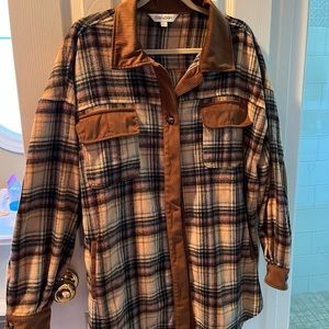 Women’s plaid oversized shacket with brown corduroy accents. Perfect for fall!
